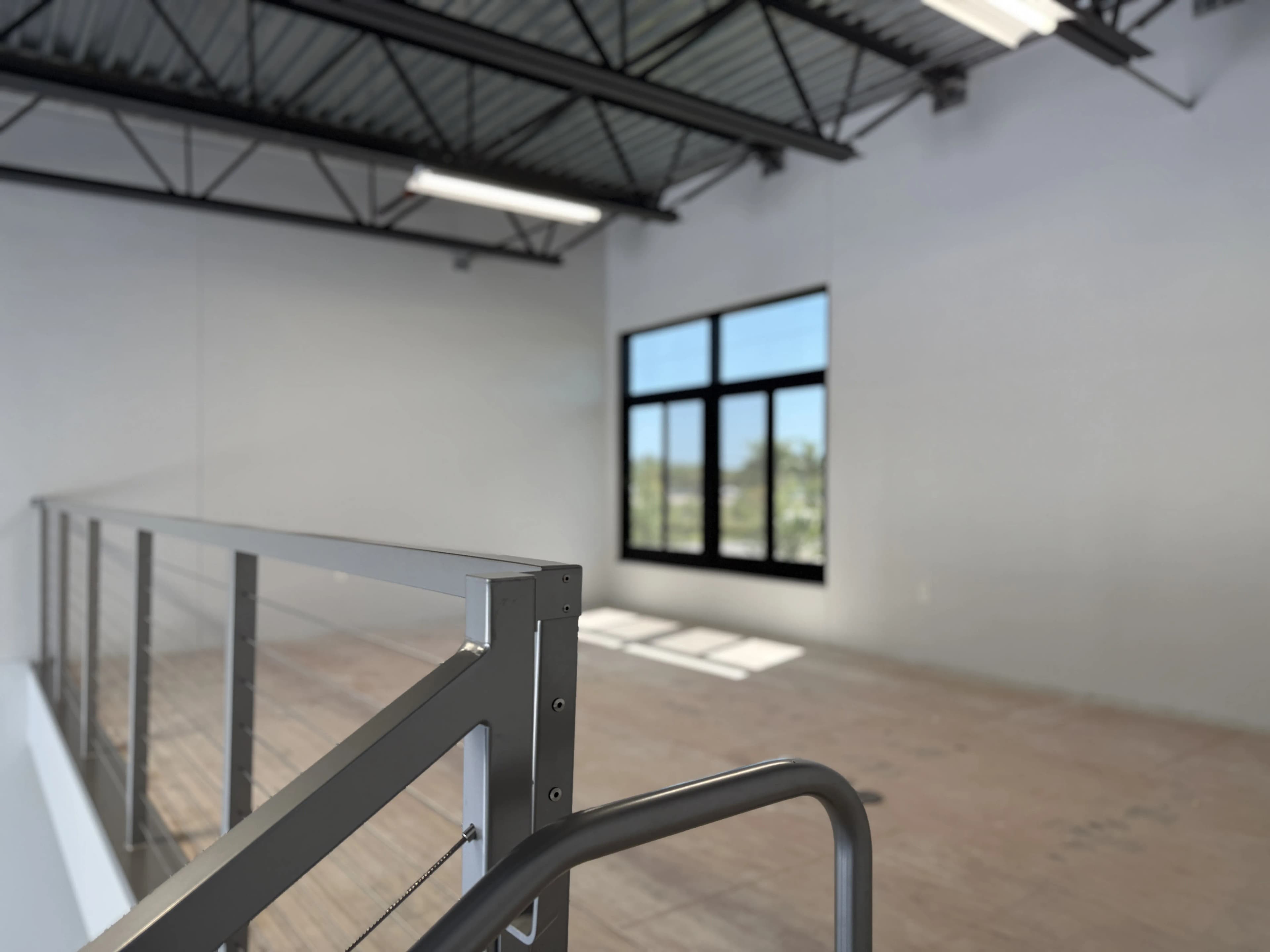 Mezzanine level from top of stairs with cable railing and large window