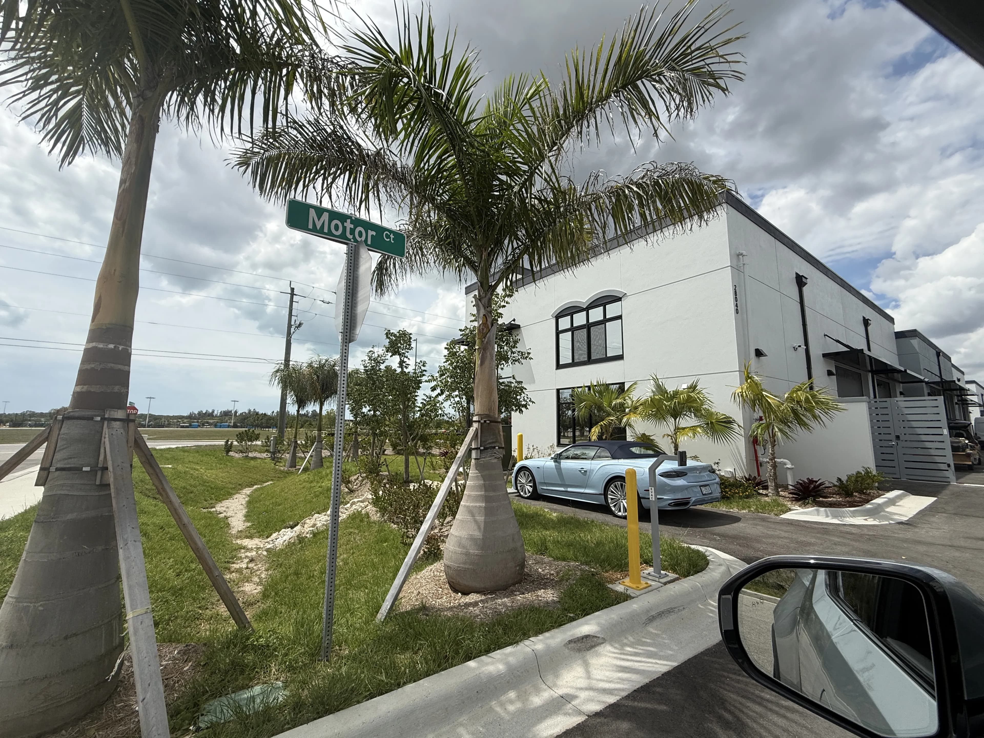 Exterior corner view with Motor Ct street sign and landscaping