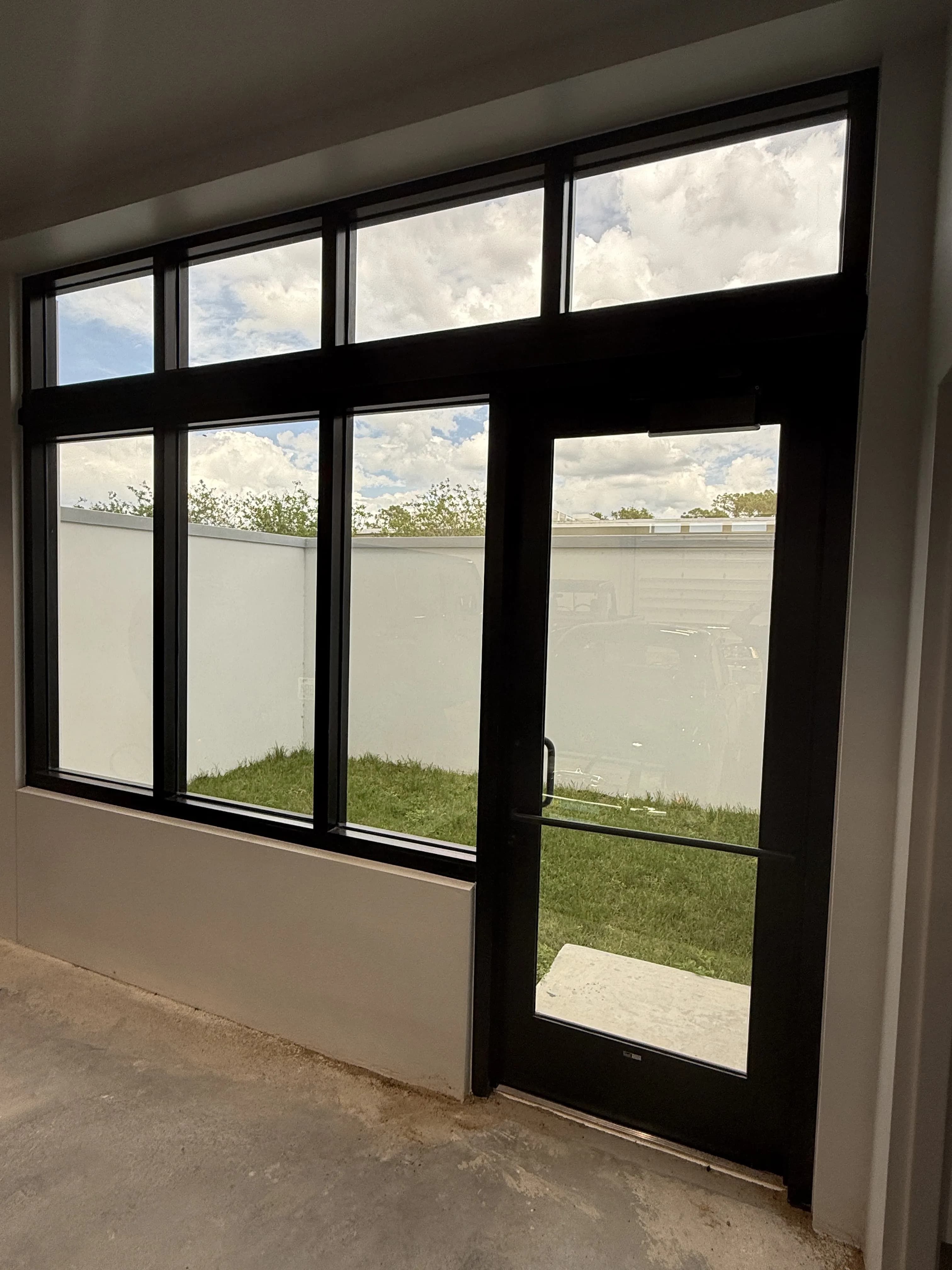 Large interior windows looking out to yard and landscaping